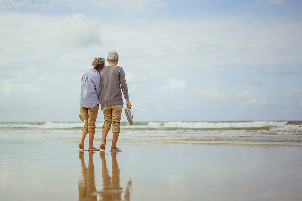 Senior couple walking on the beach